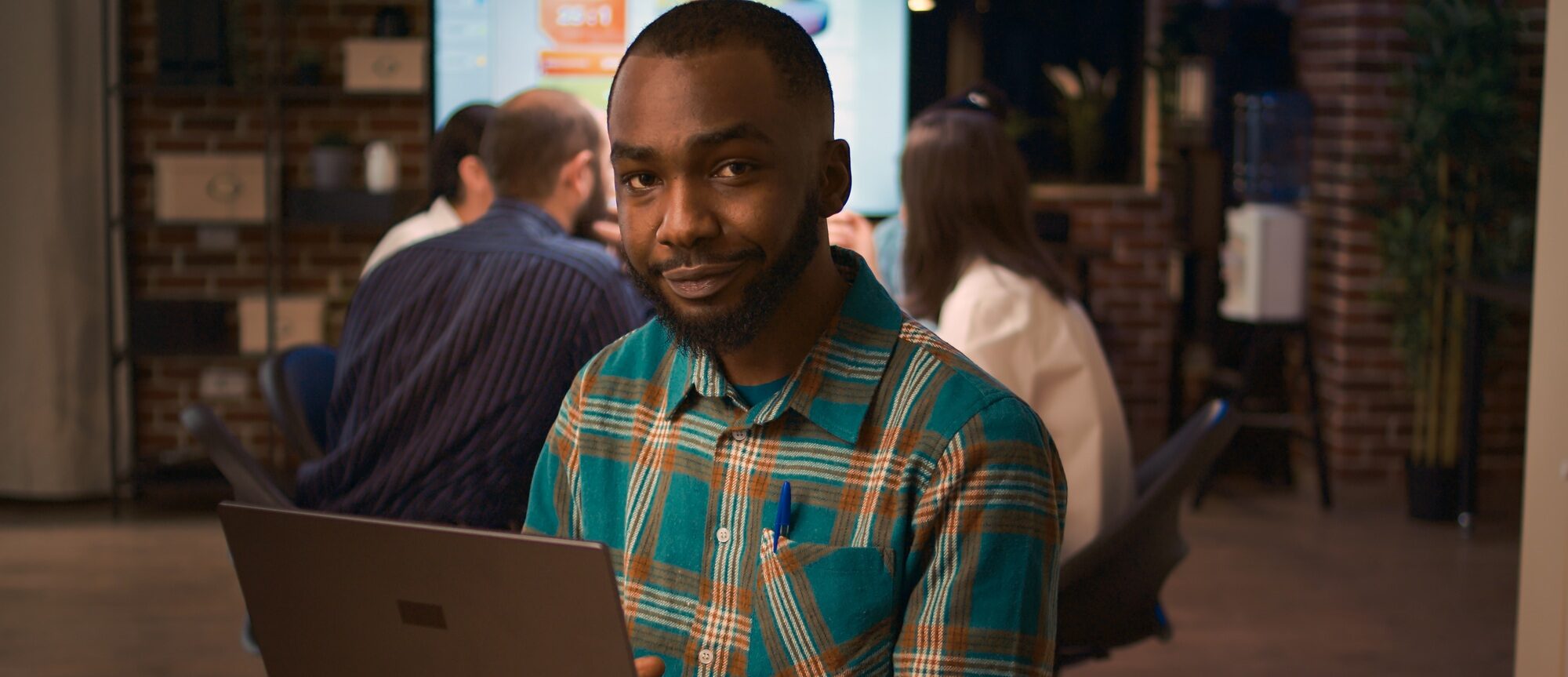 African american office employee working on laptop portrait